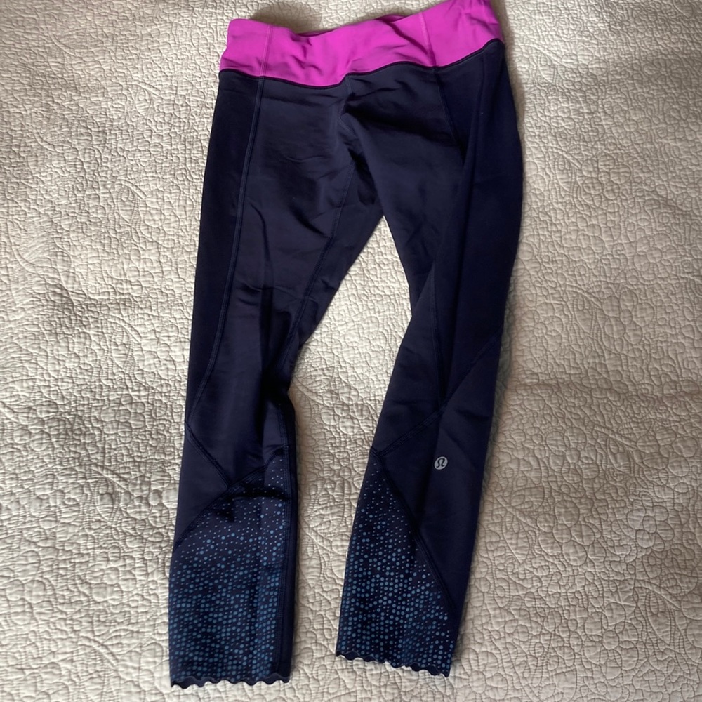 Black Lululemon leggings size 6 with purple waistband. Reflective dots detail